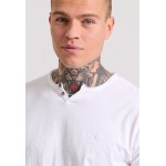 T-shirt με λαιμό henley και raw cuts - The essenti